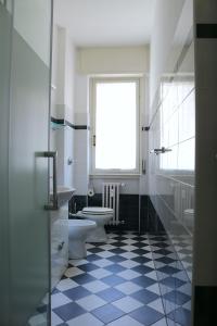 a bathroom with a toilet and a sink and a window at Frattini Comfy family Home - 4 People in Milan