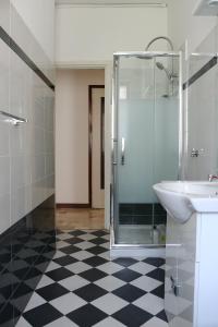 a bathroom with a glass shower and a sink at Frattini Comfy family Home - 4 People in Milan