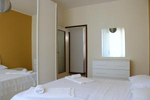 a bedroom with two beds and a large mirror at Frattini Comfy family Home - 4 People in Milan
