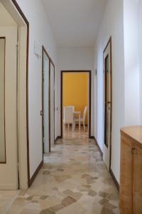 a hallway with doors and a table in a room at Frattini Comfy family Home - 4 People in Milan