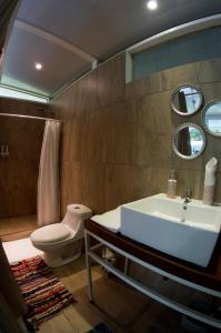 a bathroom with a sink and a toilet and a mirror at Soul Sync Sanctuary formally Hacienda la Moringa in Playa Hermosa