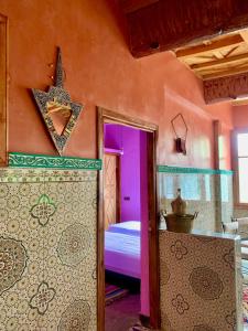 a bedroom with a bed and a star on the wall at Atlas Imsker in Marrakesh