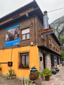 a building with a sign on the side of it at HOSPEDAJE MARISA in La Hermida