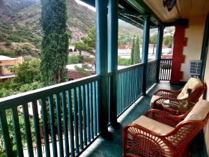 a porch with chairs and a view of a mountain at Copper Queen Hotel in Bisbee