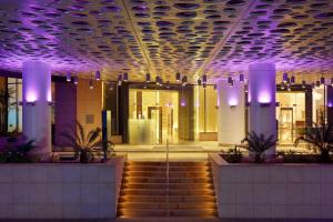 a lobby with purple lights and stairs in a building at Sheraton Cairo Hotel & Casino in Cairo