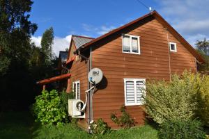 a house with a solar panel on the side of it at casa bosque in Hornopiren