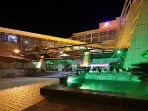 a building with a bench in front of it at night at Hotel The Cox Today in Cox's Bazar