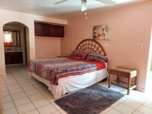 a bedroom with a bed and a table in it at 2 Bedroom 2 Bathroom House Centrally Located in Christiansted