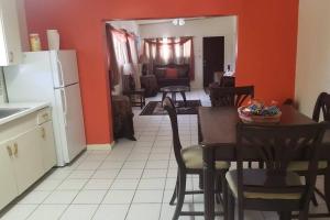 a kitchen and dining room with a table and chairs at 2 Bedroom 2 Bathroom House Centrally Located in Christiansted