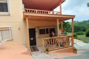 a house with a porch with a deck at 2 Bedroom 2 Bathroom House Centrally Located in Christiansted