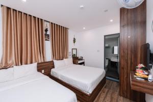 Posteľ alebo postele v izbe v ubytovaní Nguyên Hương Hotel