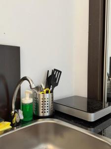 a kitchen counter with a sink and a kitchen utensils at #11 Mini ESTUDIO FAMILIAR AYAMONTE in Ayamonte