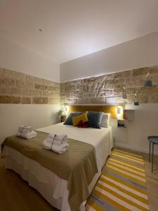 a bedroom with a large bed with towels on it at JACARANDA in Conversano
