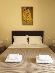 a bedroom with a bed with two towels on it at ilianas place in Ágios Matthaíos