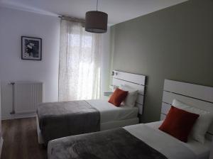 a hotel room with two beds and a window at Proche de Paris T3 tout confort in Courcouronnes