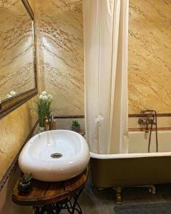a bathroom with a white sink and a bath tub at Casa Rosca in Sighişoara +104 photos