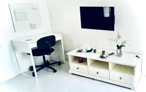 a white desk and a chair in a room at O' Cœur de Menton in Menton