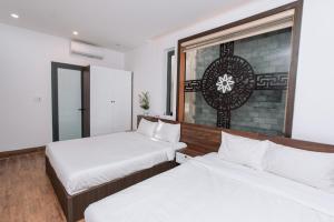 Posteľ alebo postele v izbe v ubytovaní Nguyên Hương Hotel