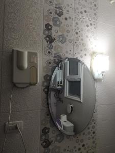 a mirror on the wall of a bathroom at 2 bedroom, 4 beds, apartment in El sheikh Zayed Cairo Egypt in Sheikh Zayed +59 photos