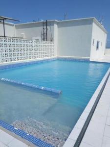 a swimming pool with blue water in a building at Medzam Homes Spacious Newly Furnished Studio in Mombasa