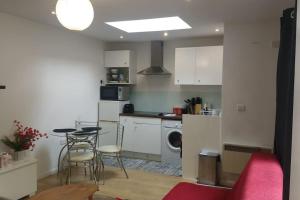 a kitchen with a table and chairs in a room at Modern Spacious Detached Cottage in Cambridge in Cherry Hinton