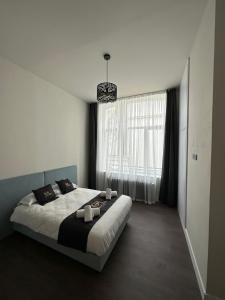 - une chambre avec un grand lit et une grande fenêtre dans l'établissement GOLDEN RESORT, à Boulogne-sur-Mer