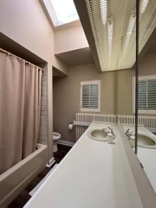 a bathroom with two sinks and a large window at 49 Hostel in Toronto