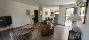 a living room with a television and a table and chairs at Casarella Alzia in Santa-Reparata-di-Balagna
