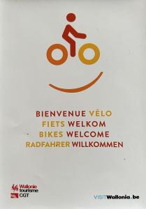 a sign with a person riding a bike at B&B La maison de Régine in Jalhay