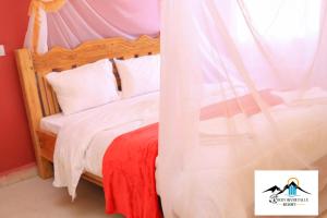 a bedroom with a bed with a canopy at Rocky river falls resort in Thika