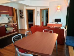 a kitchen and living room with a table and a couch at Apartment Albaré Residence in Marilleva
