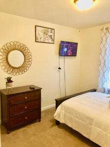 um quarto com uma cama, um espelho e uma cómoda em 3 Bedroom Home with Treadmill & Large Fenced yard em Myerstown