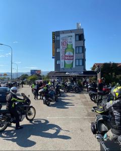 a group of people riding motorcycles in a parking lot at Hotel Banja Luka in Banja Luka