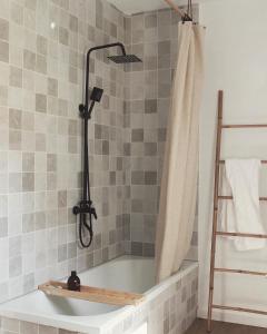a bathroom with a bath tub with a shower curtain at Villa con solarium y ducha exterior in Gelves