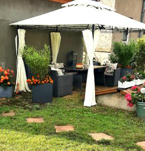 a white tent with plants and flowers in a yard at Haus Waldblick in Liebenwalde