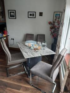 a table with two chairs and a table with a marble top at Hillside Haven in Tipperary