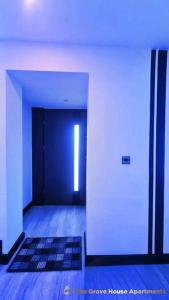 an empty hallway with a blue door and a rug at #6 TGHA Luxury Two Bedroom Apartment in Athlone in Athlone