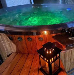 a hot tub with a table in front of it at Apartmany Milano s výrivkou a terasou in Kvakovce