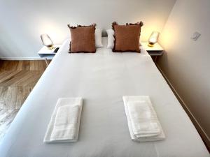 - un grand lit blanc dans une chambre avec deux oreillers dans l'établissement La Comtesse - Our Lady Church View - Heart of Dijon, à Dijon
