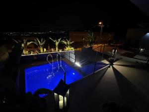 a swimming pool at night with blue lights at Suite en estancia maravillosa y romántica ideal parejas in Pineda de Mar