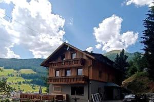 a wooden house with a view of a mountain at Alpen Apartments Salzburg in Lessach