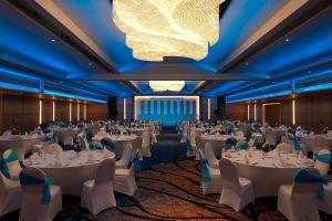 a banquet hall with white tables and chairs and a chandelier at Le Meridien Phuket Beach Resort in Karon Beach +259 photos