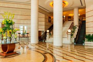 a lobby with columns and stairs in a building at Sheraton Dubai Creek Hotel & Towers in Dubai