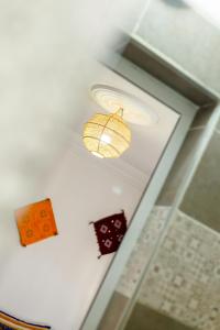 a white ceiling with a light on a door at The Rina Hostel in Agadir