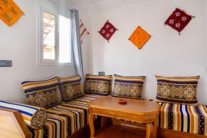 a living room with a couch and a table at The Rina Hostel in Agadir