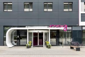 a large blue building with a pink bow on it at Moxy Frankfurt Eschborn in Eschborn