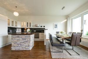 a kitchen and dining room with a table and chairs at Appartement Christine in Eben im Pongau