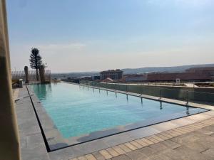 a large swimming pool on top of a building at Ellipse Waterfall luxurious unit in Midrand