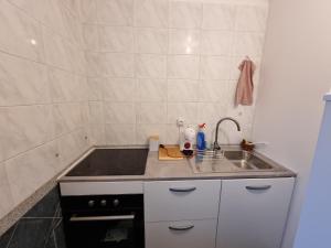 a kitchen with a sink and a counter top at Chambre cosy in Persan