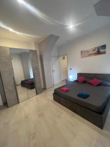 a bedroom with a large bed and a mirror at Guest House Villanova in Cagliari